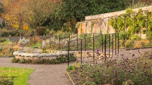 Berrington's fountain surrounded by autumnal gardens.